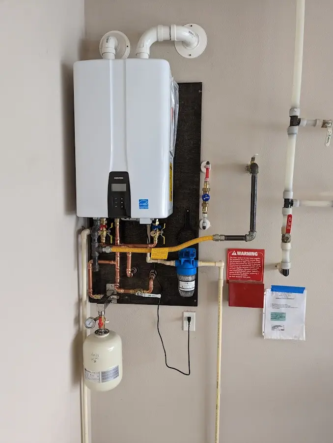 Professional plumber installing copper piping in a Mount Zion home